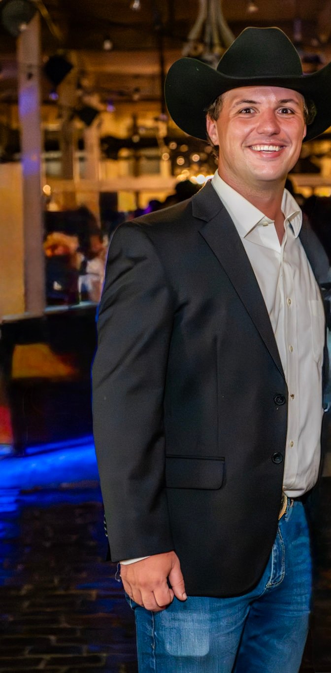 Andrew Gochis in a black cowboy hat and blazer